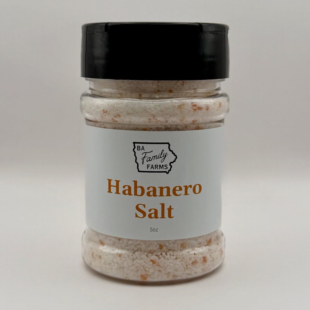 A jar of Habanero Salt from BA Family Farms, featuring a white label with orange text and a black lid, set against a plain light gray background.