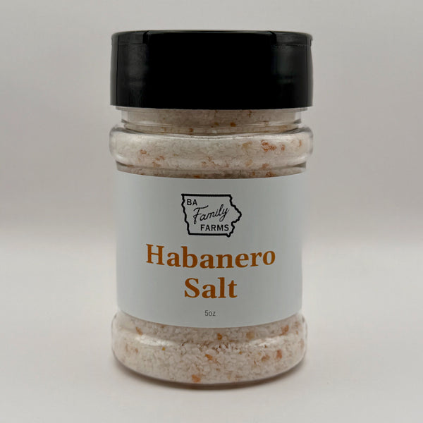 A jar of Habanero Salt from BA Family Farms, featuring a white label with orange text and a black lid, set against a plain light gray background.