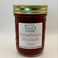A glass jar of BA Family Farms Strawberry Rhubarb Jam with a white label and a gold metal lid, set against a plain light gray background.